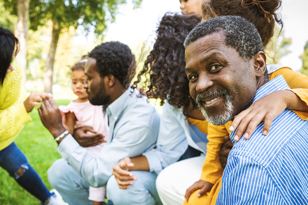 A family at risk for hereditary kidney disease relaxes and bonds in a local park.